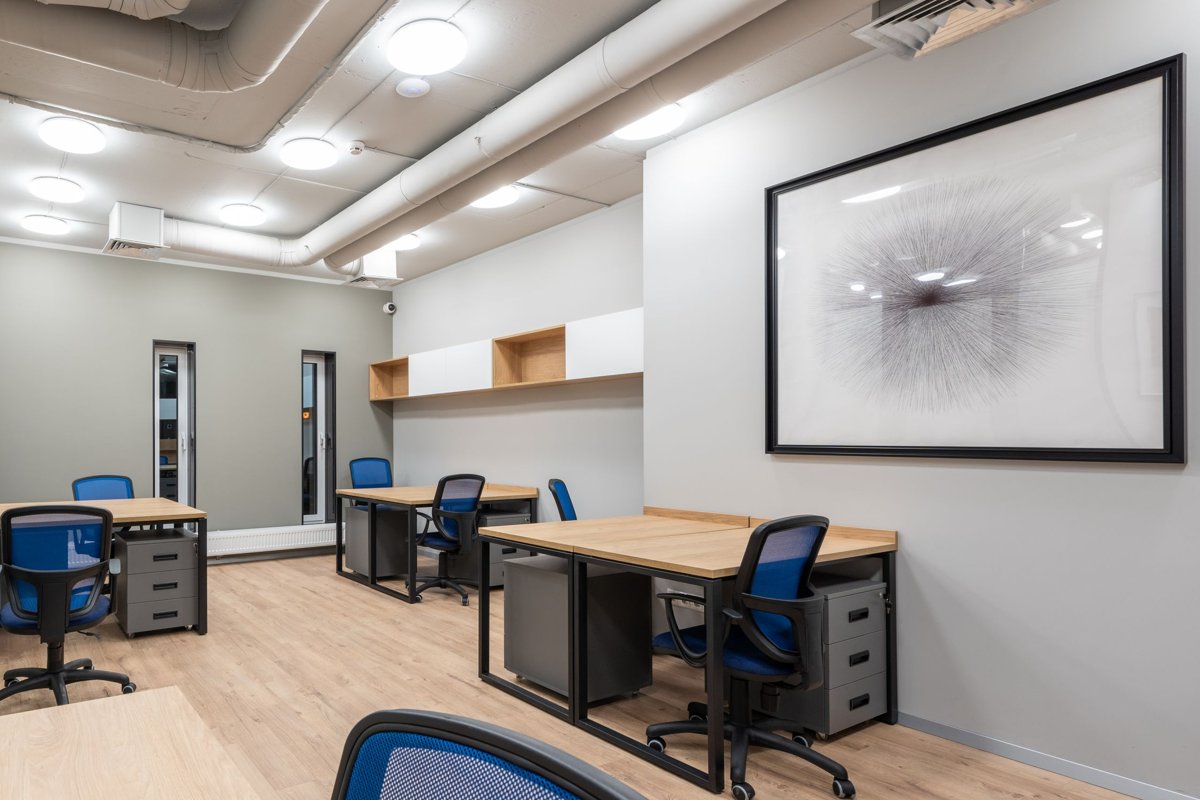 Office with individual desks, file pedestals, and blue task chairs