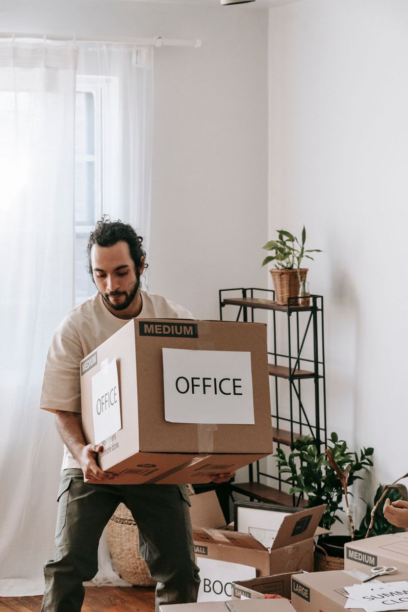 Mover carrying a box labeled office